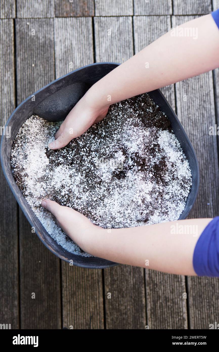 Mixing two types of compost in bucket Stock Photo Alamy