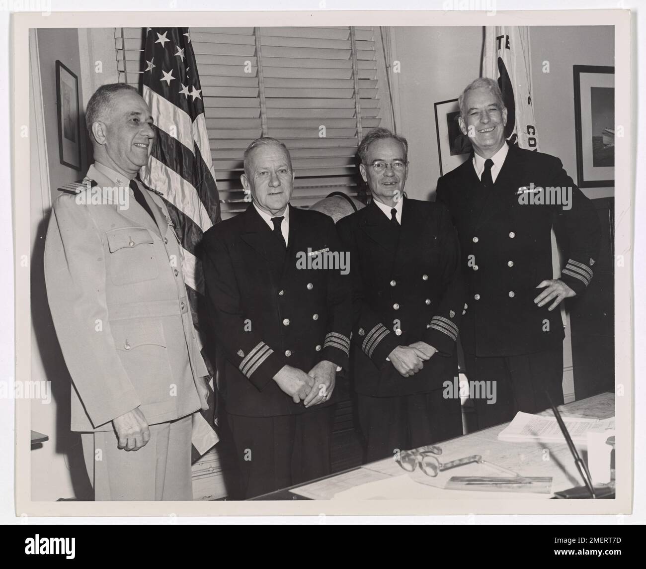 Retirement day for two USCG Commanders, Thomas S. Coffee and Francis R. Dillenkoffer. This picture shows 'retirement' day for two USCG Commanders, Thomas S. Coffee (2nd from left) and Francis R. Dillenkoffer (extreme right). The others shown are Captain Frank A. Leamy (far left) and commander J. F. Kettler (second from right). Stock Photo