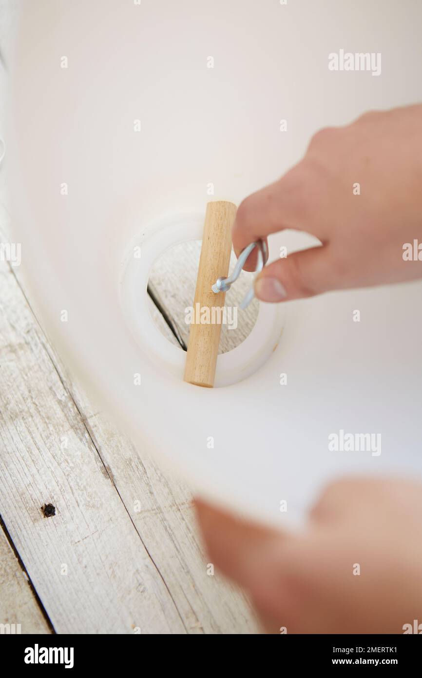 Measuring piece of dowel and hook at opening of lampshade for upside