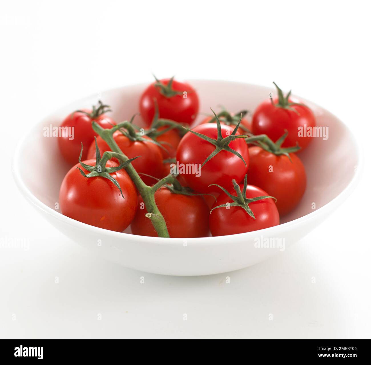 Cherry tomatoes on the vine Stock Photo