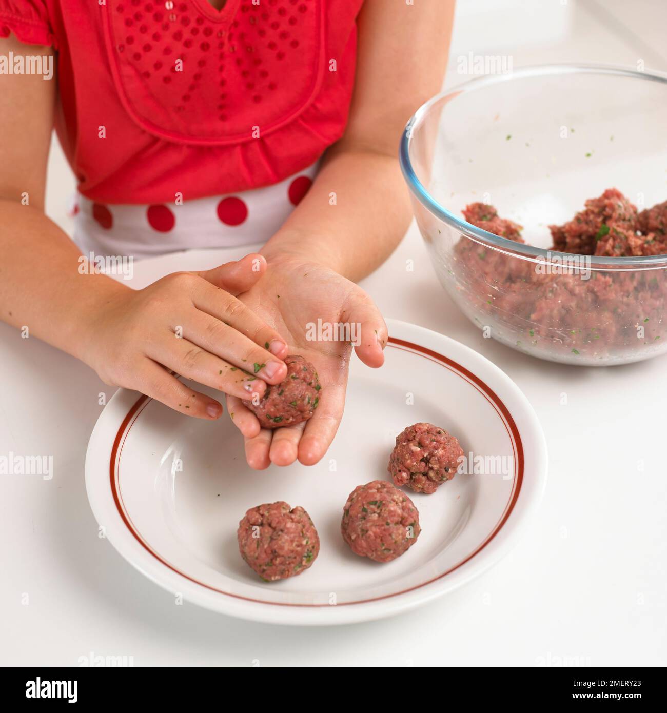 Girl molding meatballs from mincemeat Stock Photo Alamy