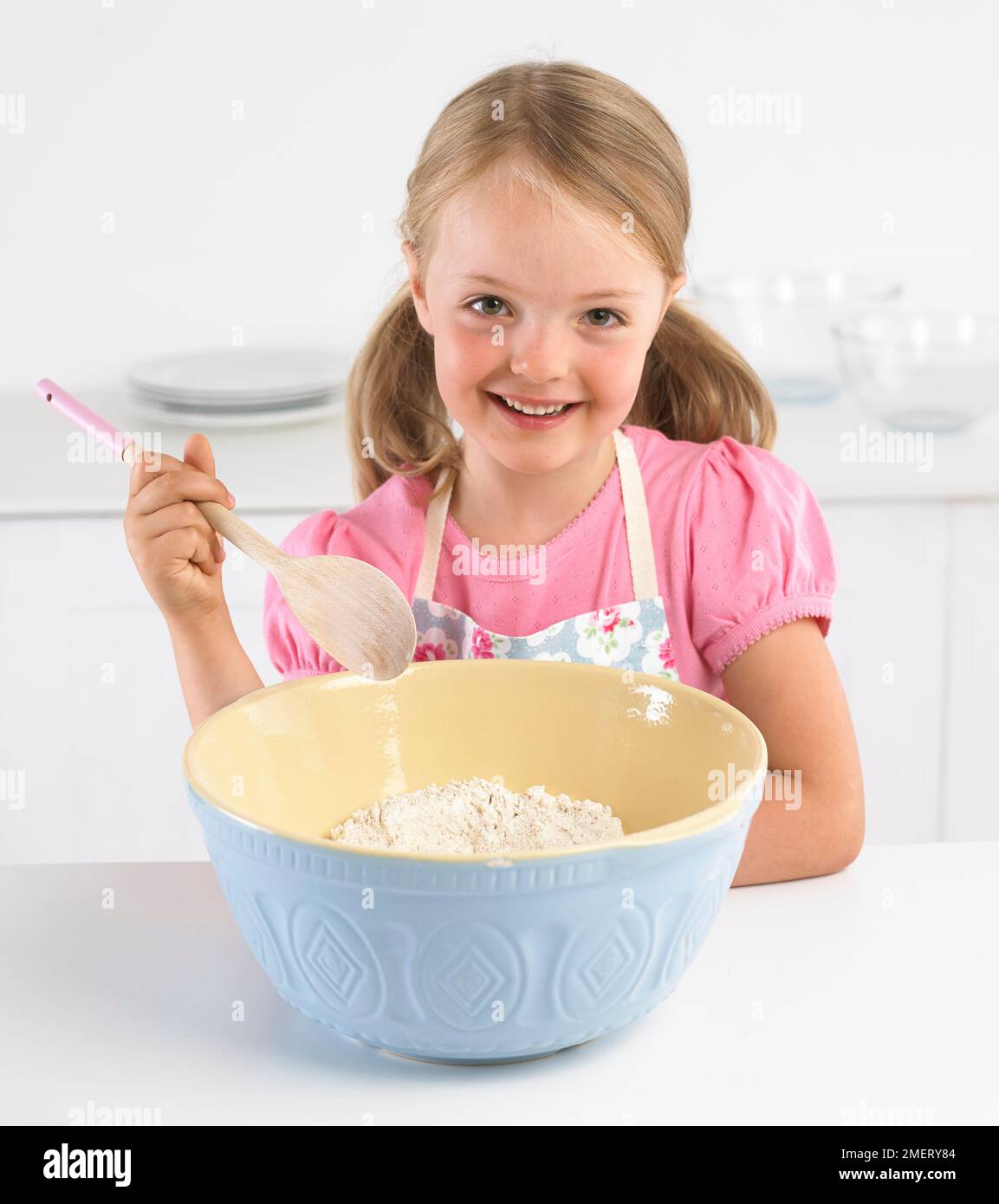 Girl mixing bowl of flour, 5 years Stock Photo Alamy