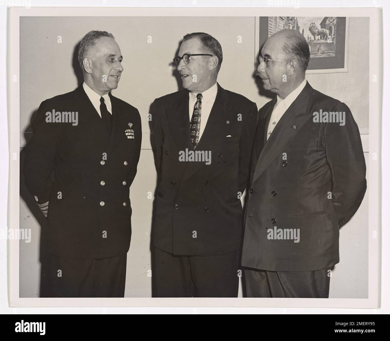 Captain Frank A. Leamy and newly appointed officers of the 8th Coast Guard District Auxiliary. Future plans of the Coast Guard Auxiliary are discussed by Captain Frank A. Leamy (left), USCG, Commander, 8th Coast Guard District, and newly appointed officers of the 8th Coast Guard District Auxiliary. Next to Captain Leamy stands L. J. Trudeau who was sworn in as Commodore of the 8th District Auxiliary, and Dr. J. W. Rosenthal who became Captain of Division #4. The two new officers, both native sons of the Crescent City, were administered their oath's of office during the District Auxiliary's Ins Stock Photo