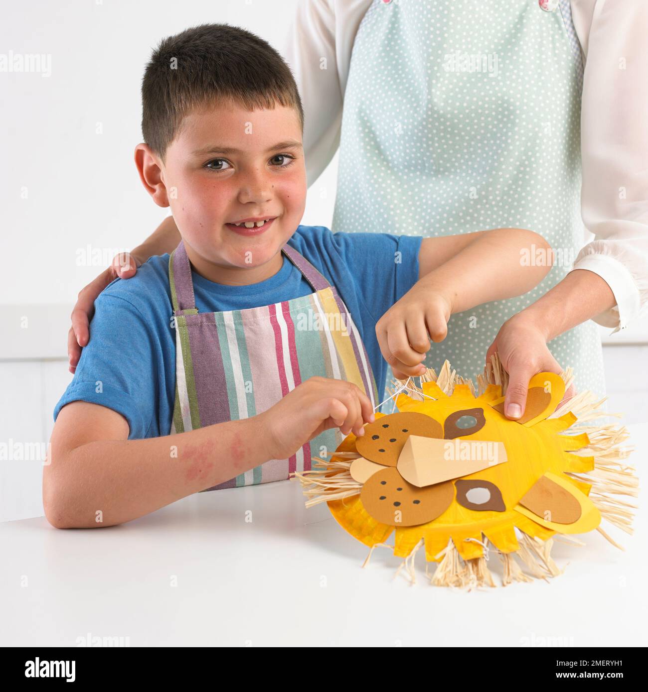 Boy making a lion mask, 7 years Stock Photo Alamy