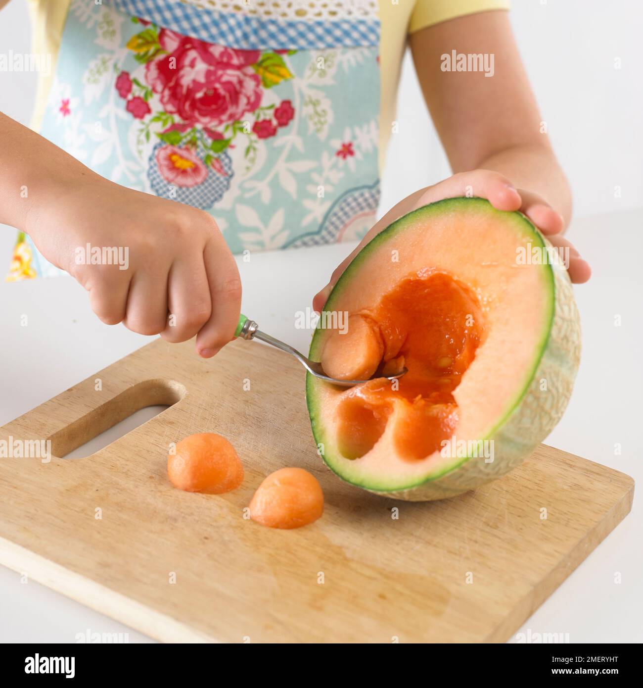 Girl balling a melon Stock Photo