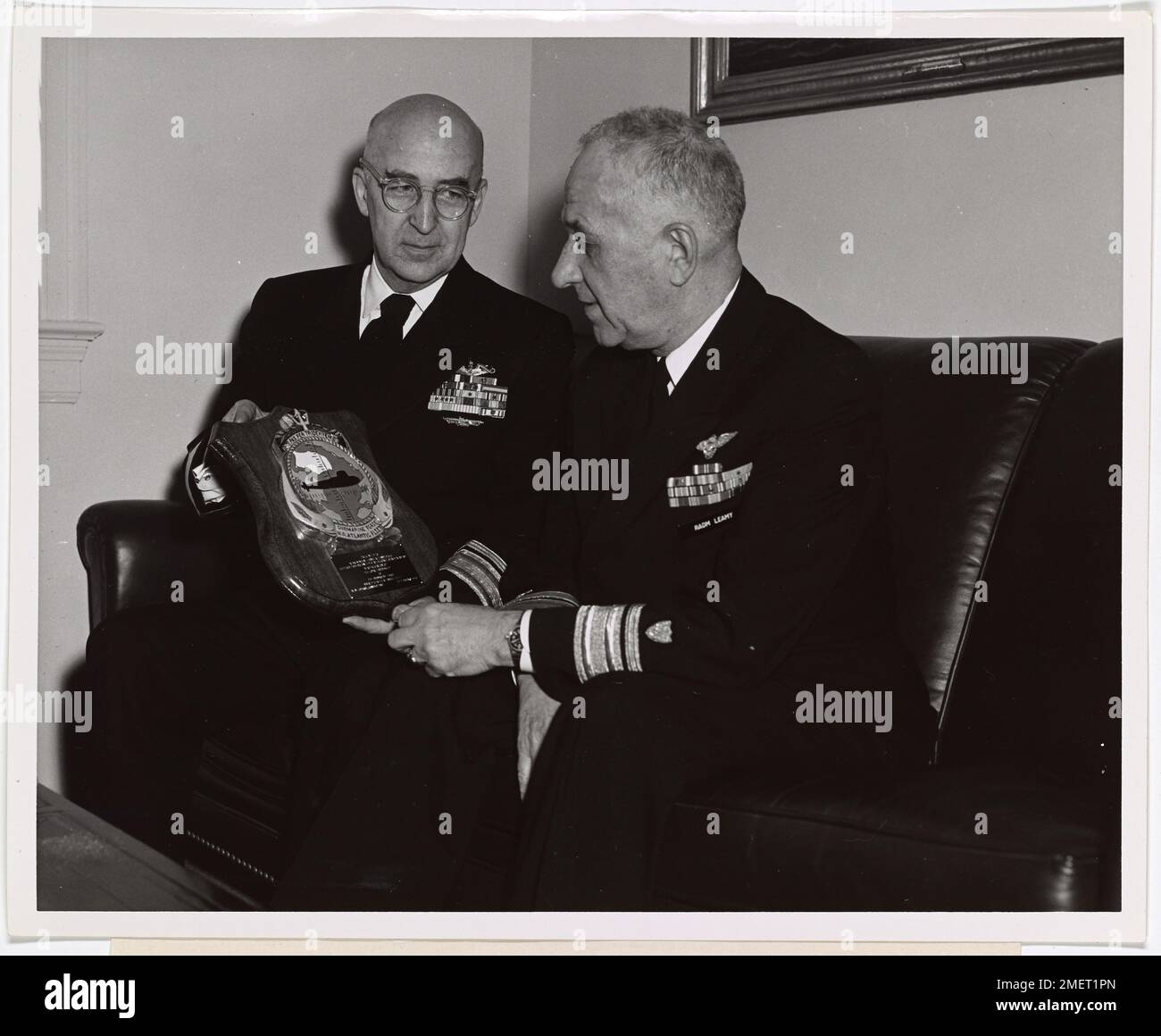 Rear Admiral Lawrence R. Daspit of the U.S. Navy presents a plaque to ...