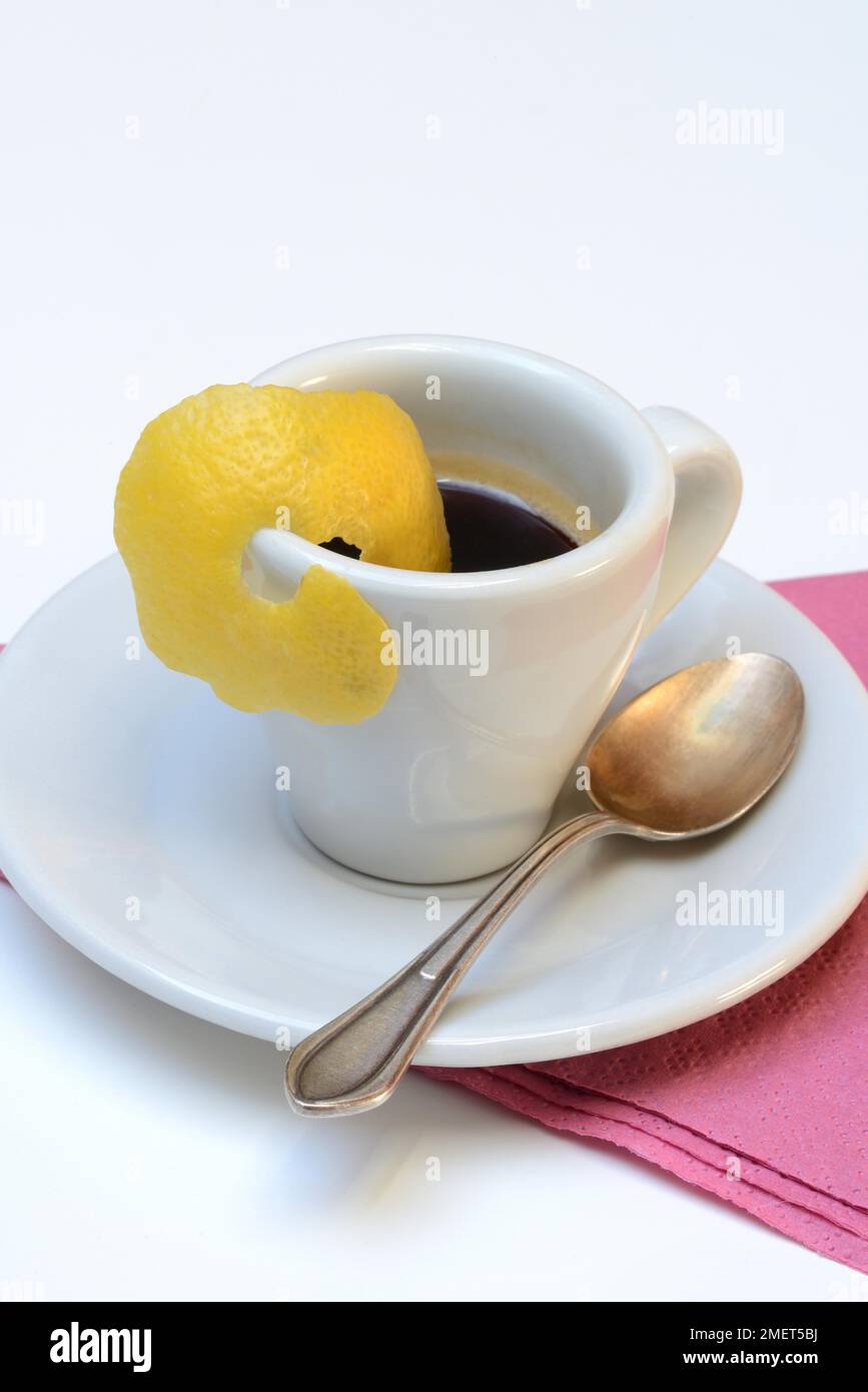 Espresso Romano, cup of espresso with lemon zest, coffee preparation Stock Photo