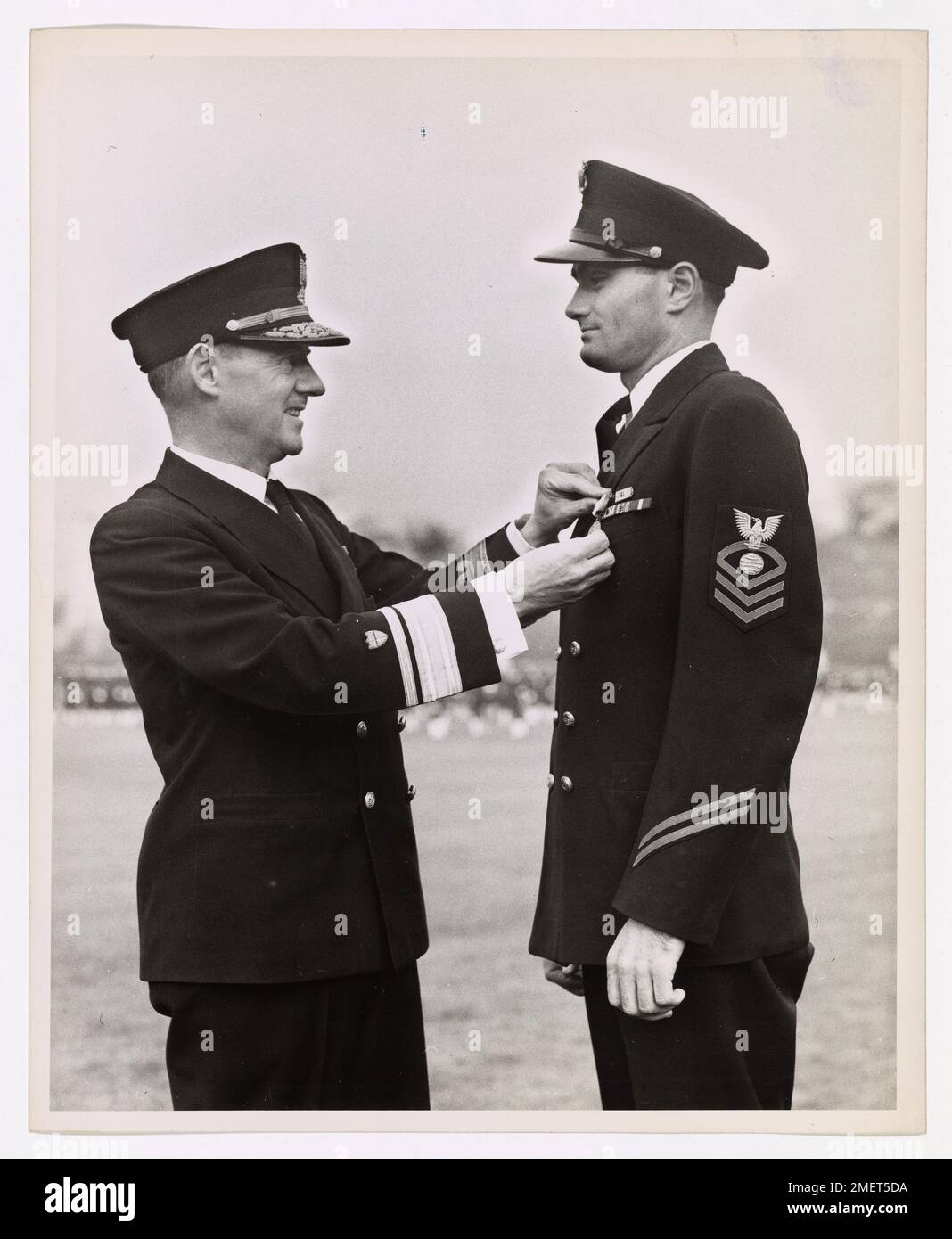 Chief Electrician's Mate John T. Hendrix, U.S. Coast Guard, was awarded the Navy and Marine Corps Medal for rescuing 144 crew members of a merchant ship lost in the North Atlantic during March 1943. Hendrix's heroism was recognized during a ceremony led by Rear Admiral James Pine. Stock Photo