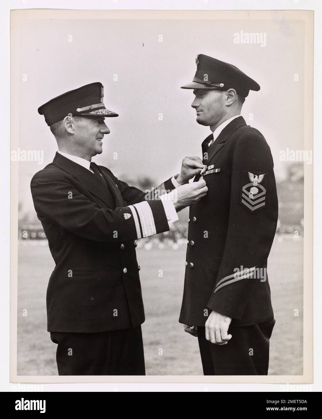 Coast Guard Chief decorated for heroism. John T. Hendrix, Chief Electrician's Mate, U.S. Coast Guard, wins the Navy and Marine Corps medal for his part in the rescue of 144 crew members of a stricken merchantman, lost in the North Atlantic during March, 1943. Hendrix's citation, read by Rear Admiral James Pine, superintendent of the U.S. Coast Guard Academy, New London, Connl, during the decoration ceremonies, stipulates the award is 'for outstanding heroism.' Chief Hendrix is a Coast Guard veteran with two hitches to his credit and two full years of convoy and anti-submarine duty chalked up o Stock Photo