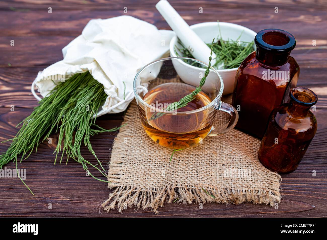 cup of tea from horsetail, made from fresh potion, from pharmacy mortar. Horsetail infusions are used as diuretic for edema Stock Photo