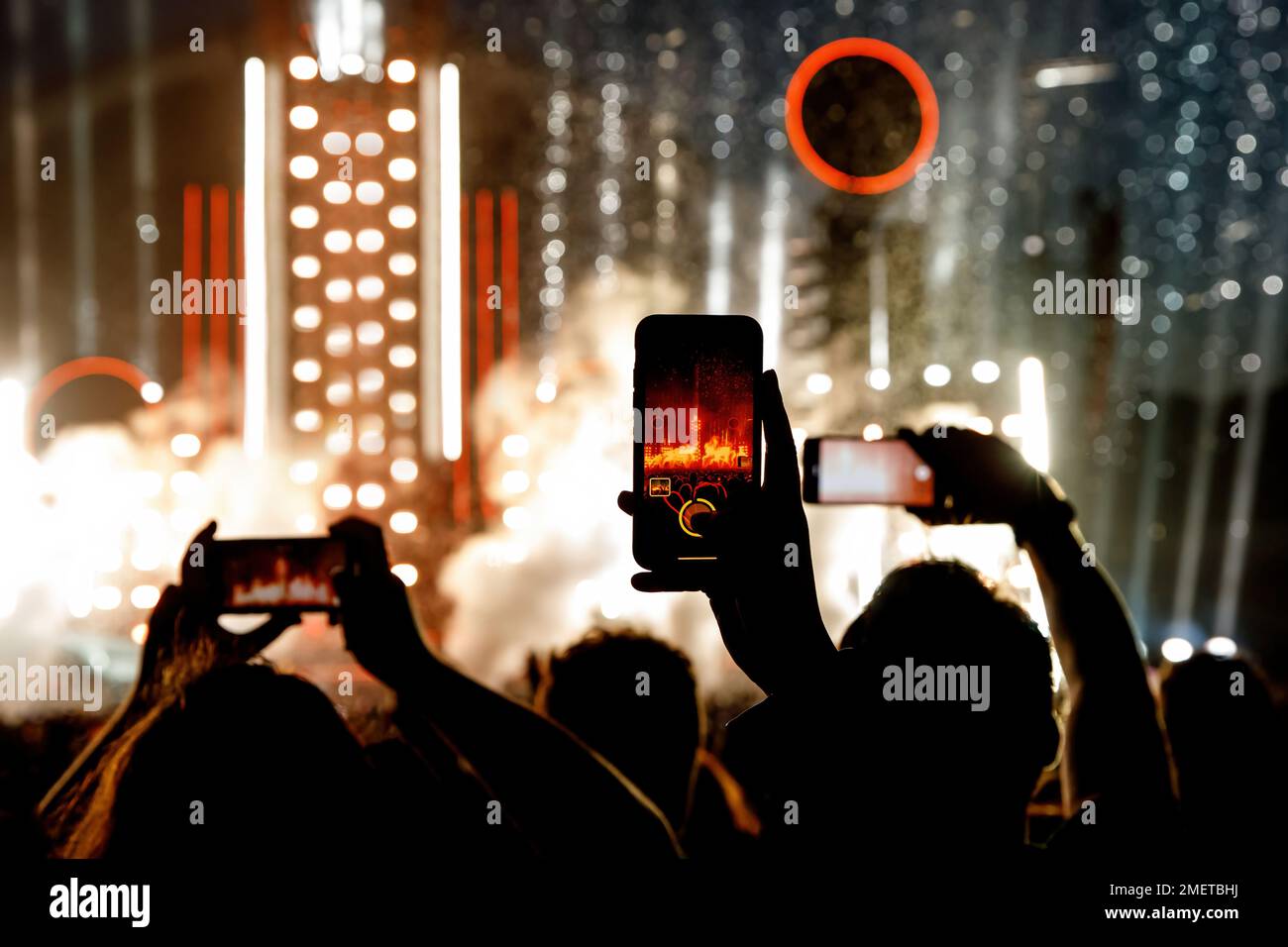 Hand with a smartphone record live music festival and taking photos of