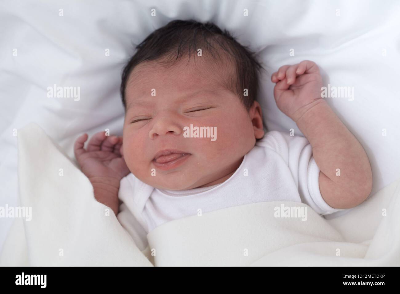 Baby girl with her eyes closed and tongue sticking out Stock Photo - Alamy