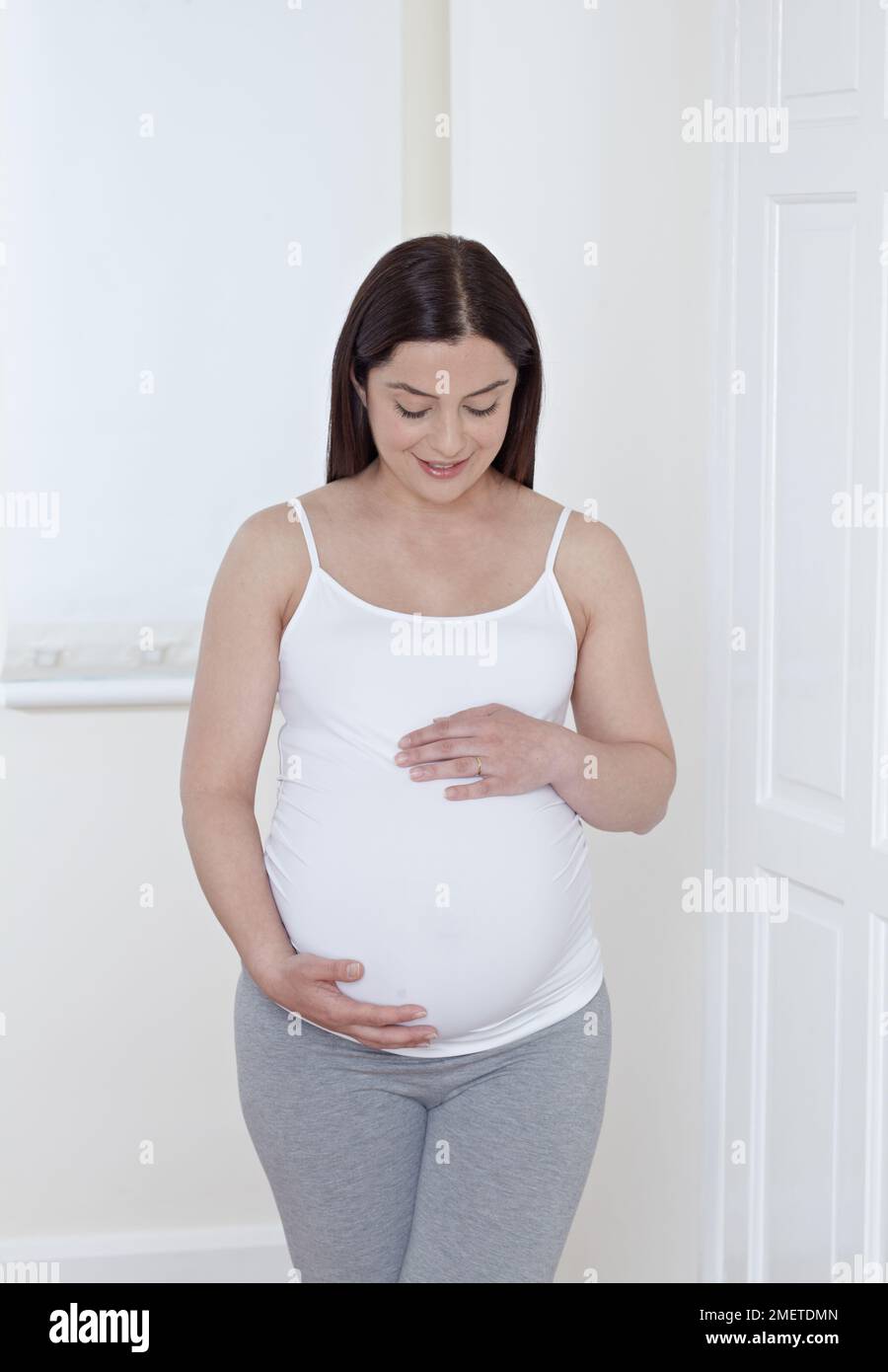 Pregnant woman holding her belly Stock Photo