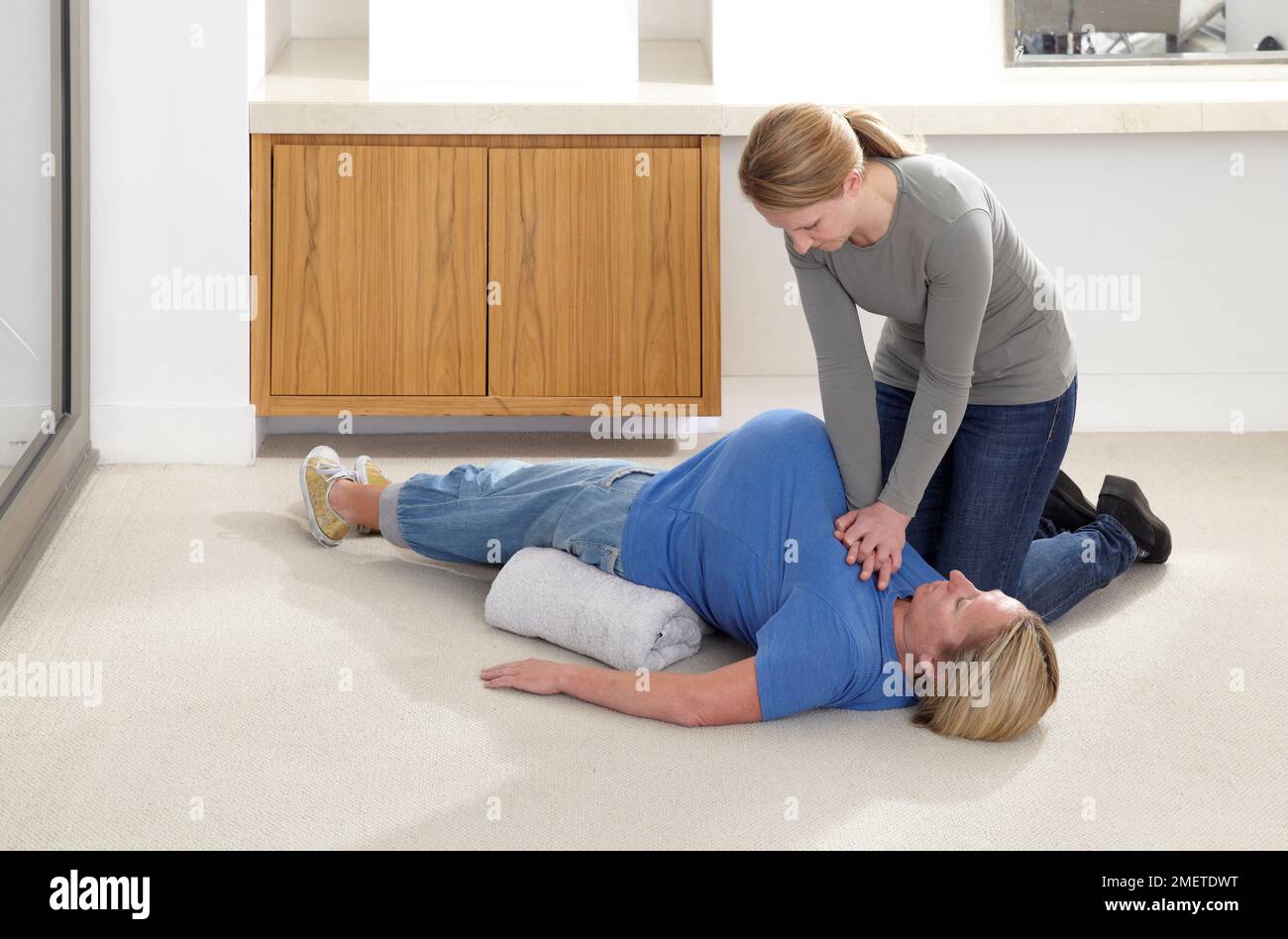 First aid treatment on pregnant woman, chest compression CPR Stock Photo