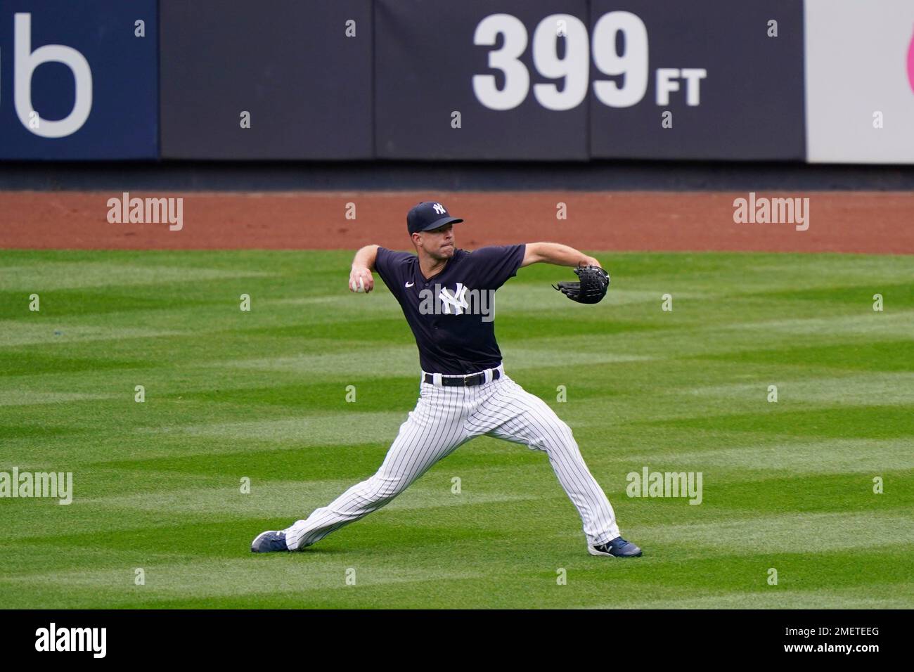 New York Yankees starting pitcher Corey Kluber throws in the outfield