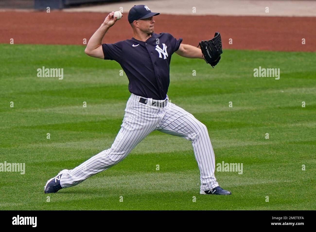New York Yankees starting pitcher Corey Kluber throws in the outfield