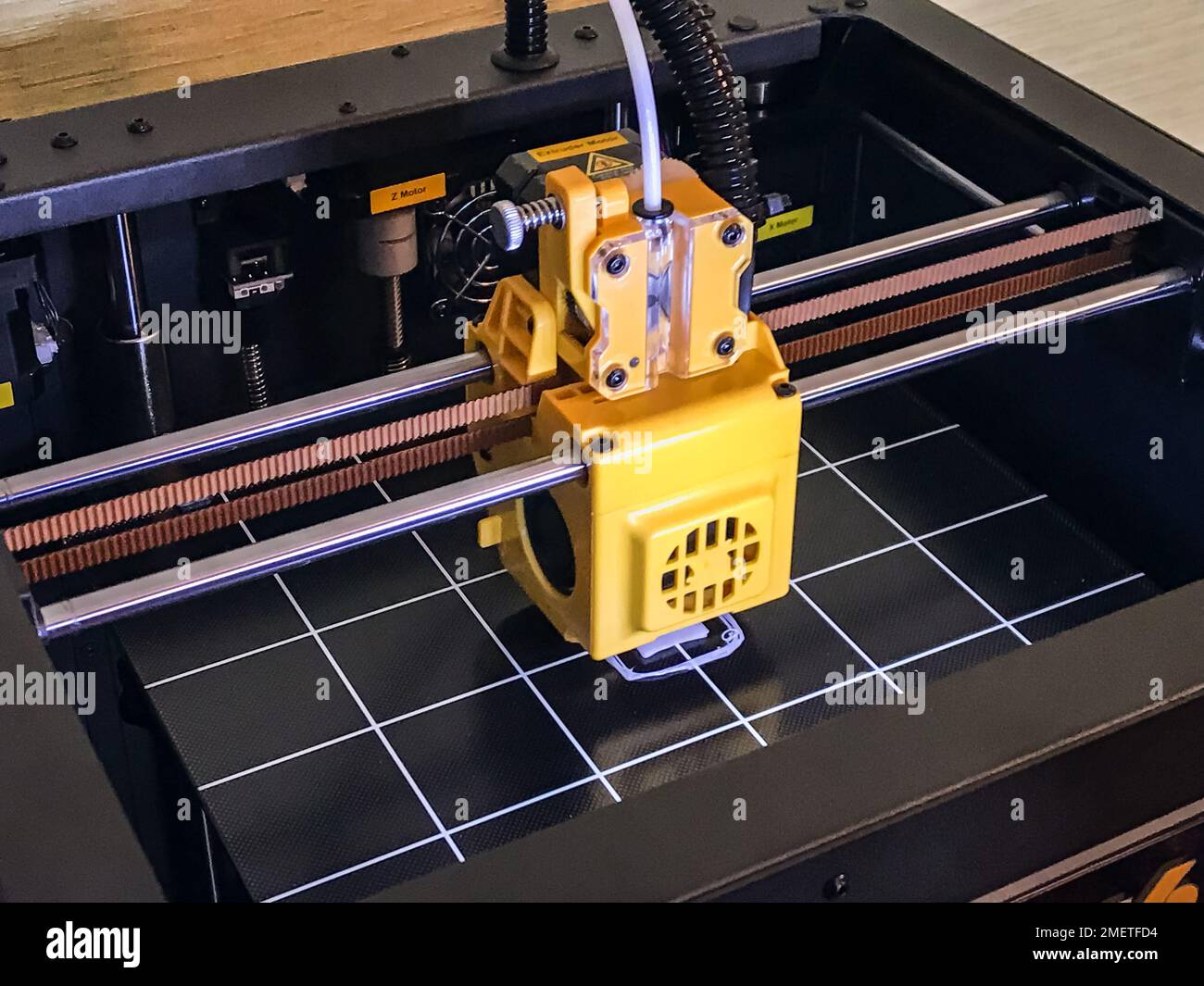 printer 3d device with numerically controlled machine,along the rails of the head extruder,prints creates models details of a figure made of polymer p Stock Photo
