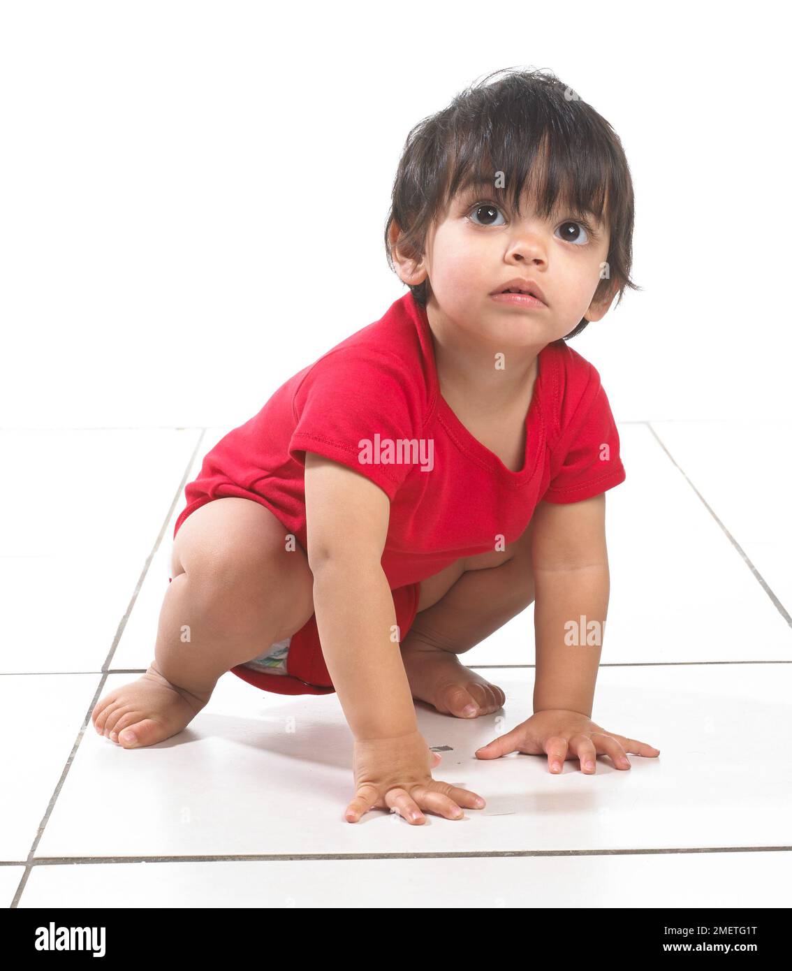 Baby boy (16 months) squatting Stock Photo Alamy