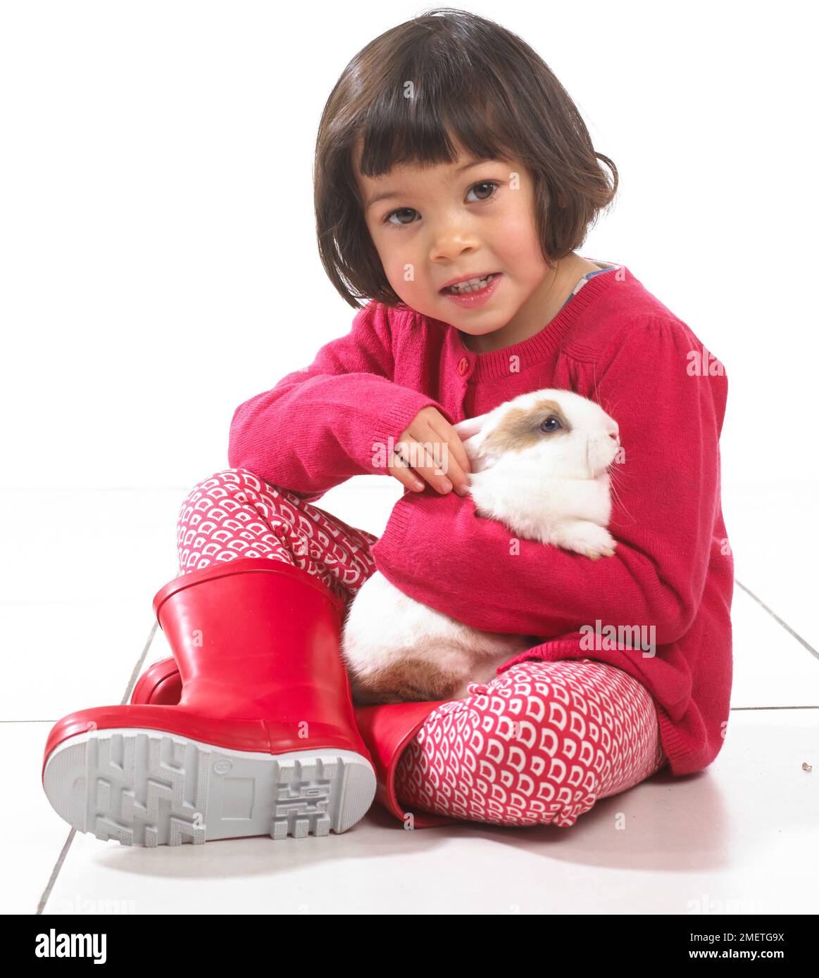 Young girl hugging white rabbit, 2 years Stock Photo - Alamy