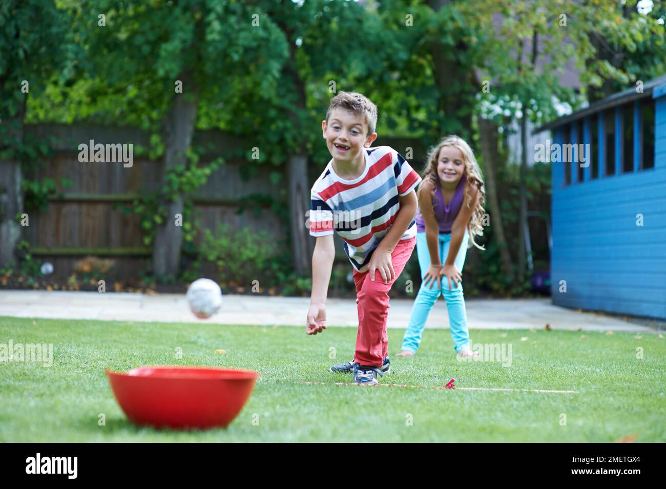 Boy and girl playing ball target game Stock Photo Alamy