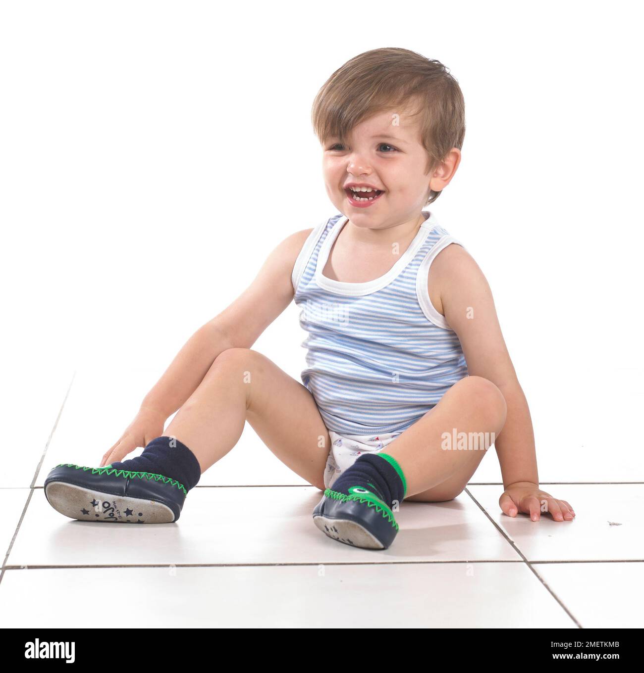Boy sitting on the floor, 20 months Stock Photo