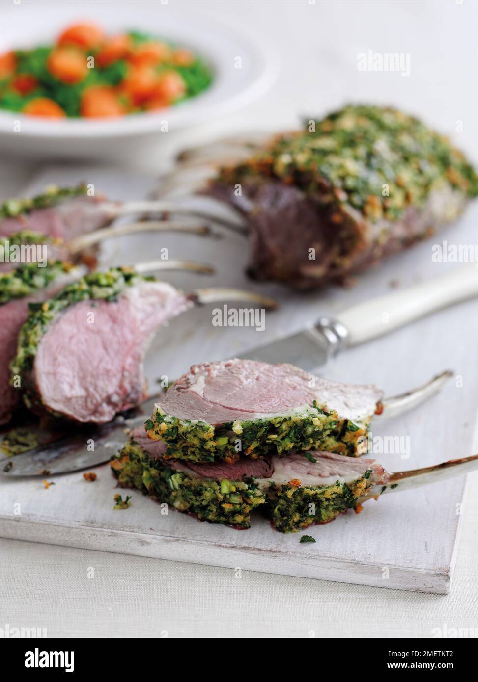 Roast rack of lamb with herb crust, cut in slices Stock Photo Alamy