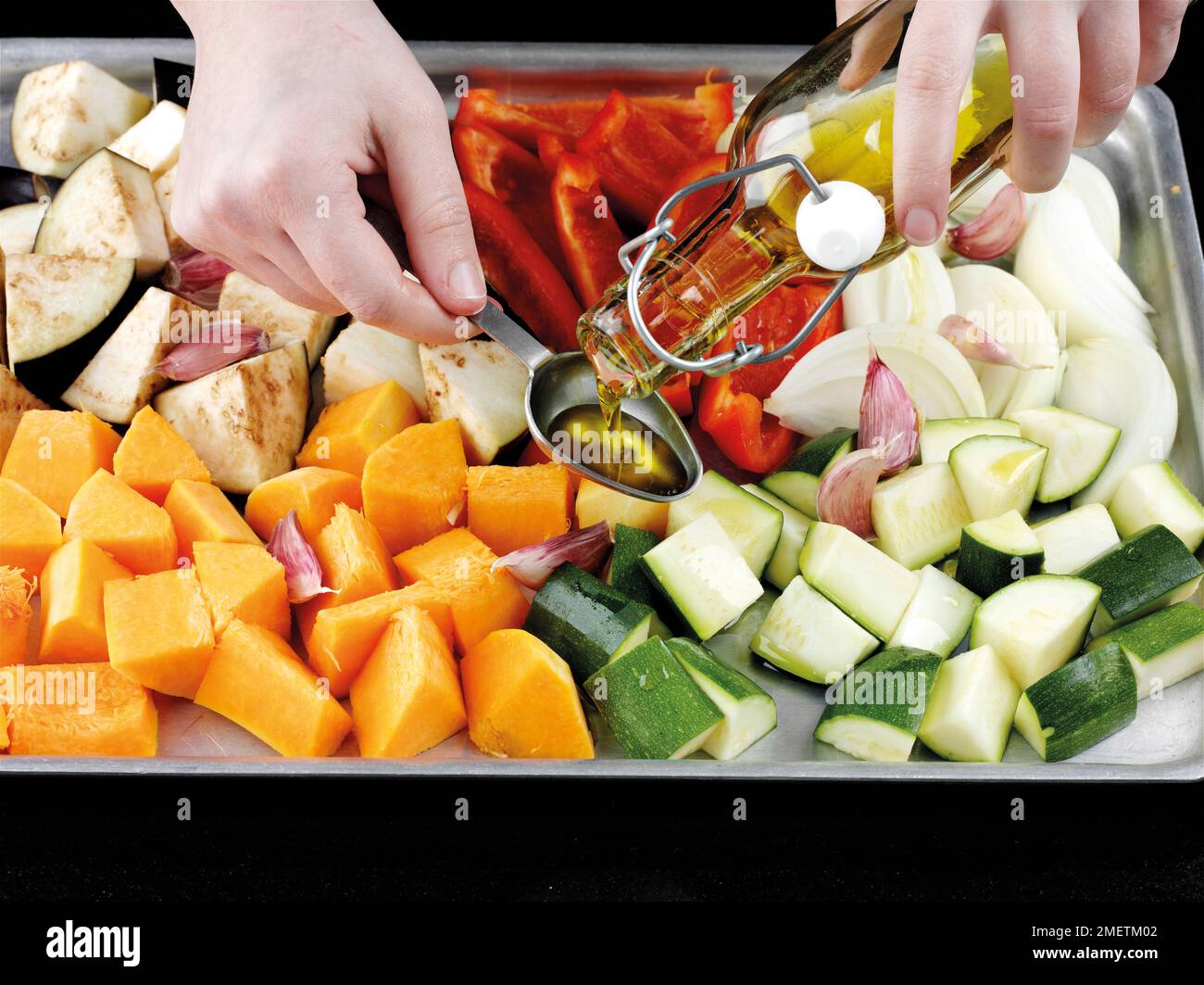 Roasting vegetables (courgettes, aubergines, onions, red peppers