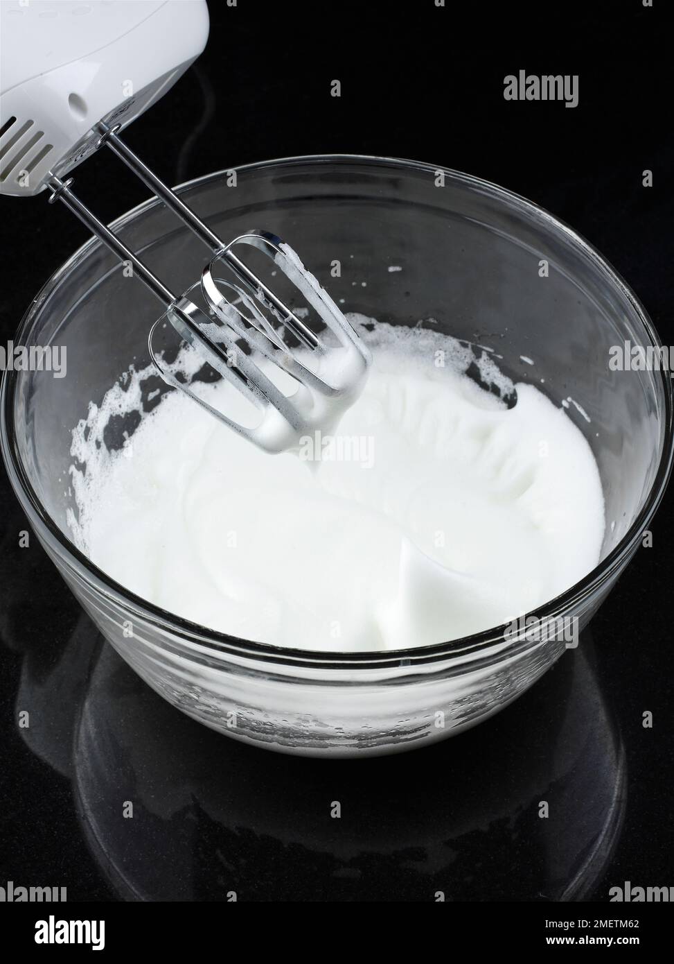 Making cheese souffles, whisking egg whites in mixing bowl, using an