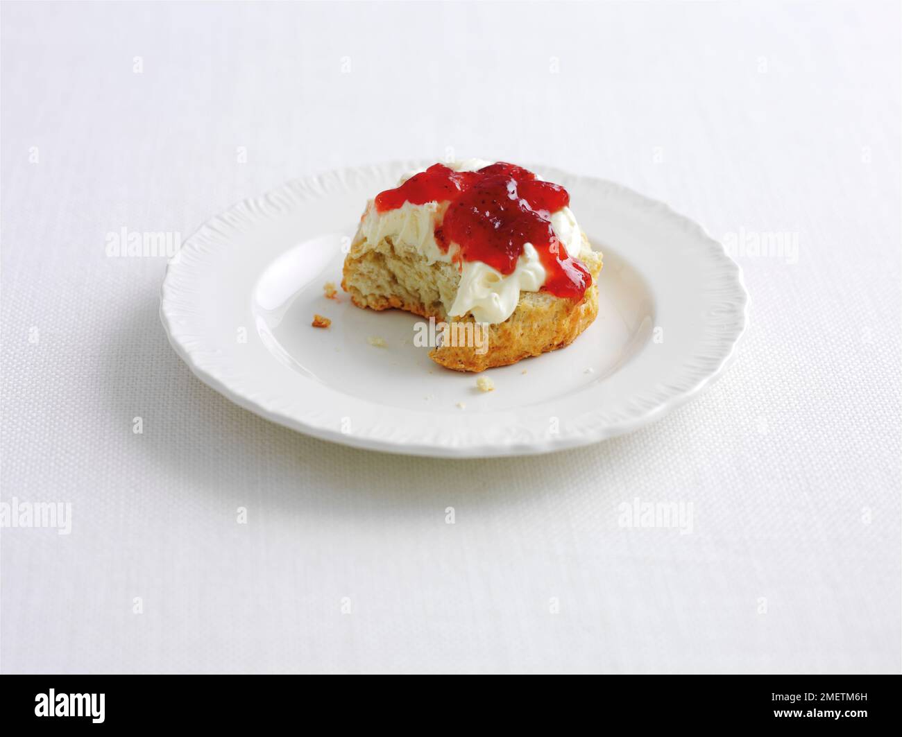 Scone with jam and clotted cream Stock Photo