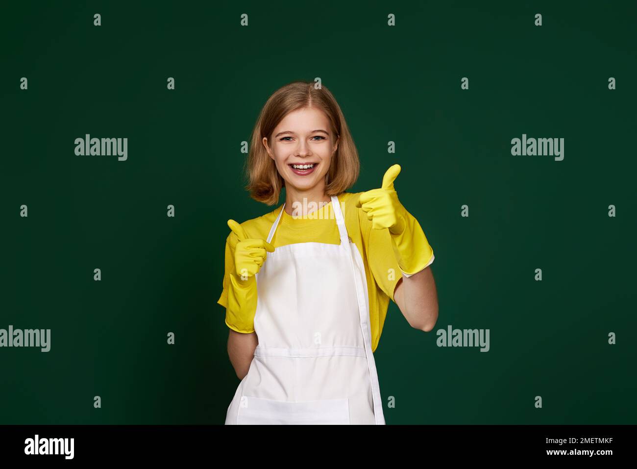 woman in rubber gloves and cleaner apron showing ok sign Stock Photo ...