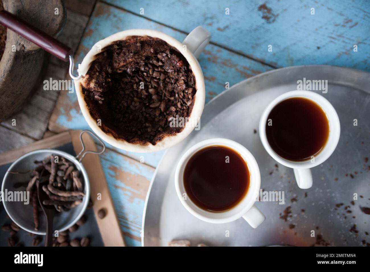 Caffe Touba, pouring hot water into coffee draining through a cloth Stock Photo