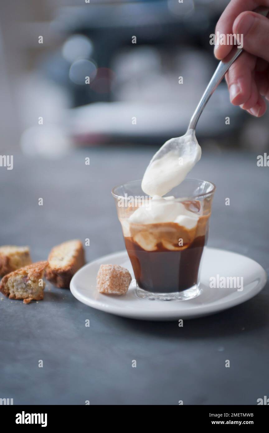 Espresso con panna, adding whipped cream to the top of an espresso shot
