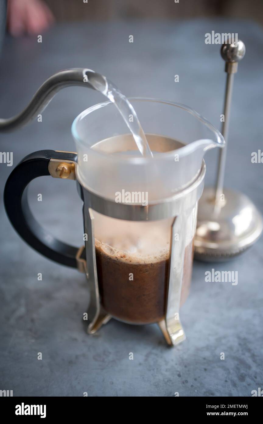 Pouring hot water in a filterstyle brewer Stock Photo Alamy