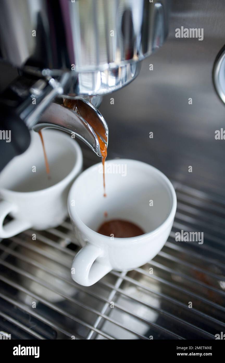 Coffee dripping from espresso machine Stock Photo Alamy