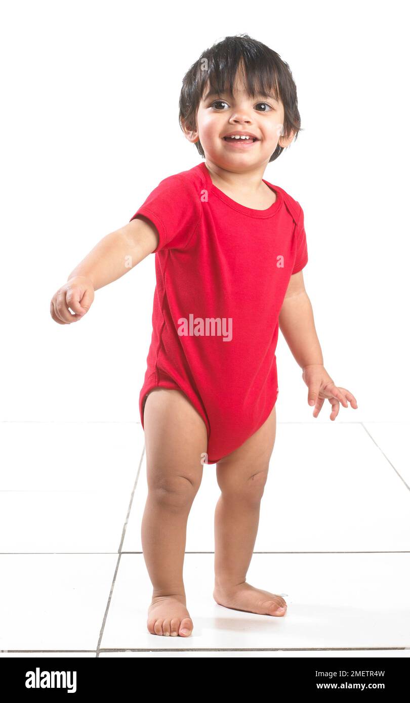 Baby boy (16 months) standing up Stock Photo