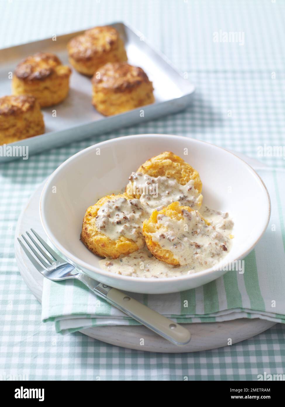 Biscuits (savoury scones) with creamy sausage gravy Stock Photo - Alamy