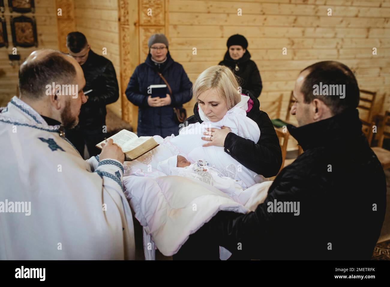 Baptism in the Greek Catholic Church, Anastasia was born on 4. 3. 22 in Kyiv, the father brought his woman under fire from the Russian army to a Stock Photo