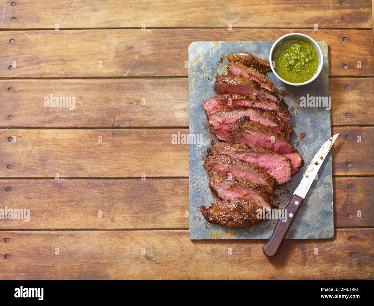Dryrub steak with chimichurri sauce Stock Photo Alamy