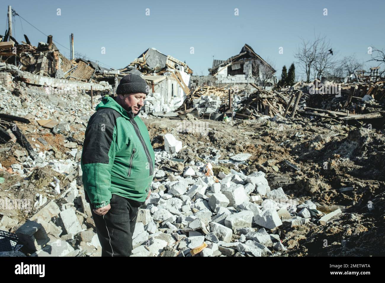 Serhiy Melnyk stands on the ruins of his house in the residential district of Bohunia, which was destroyed in a Russian missile attack on the night Stock Photo