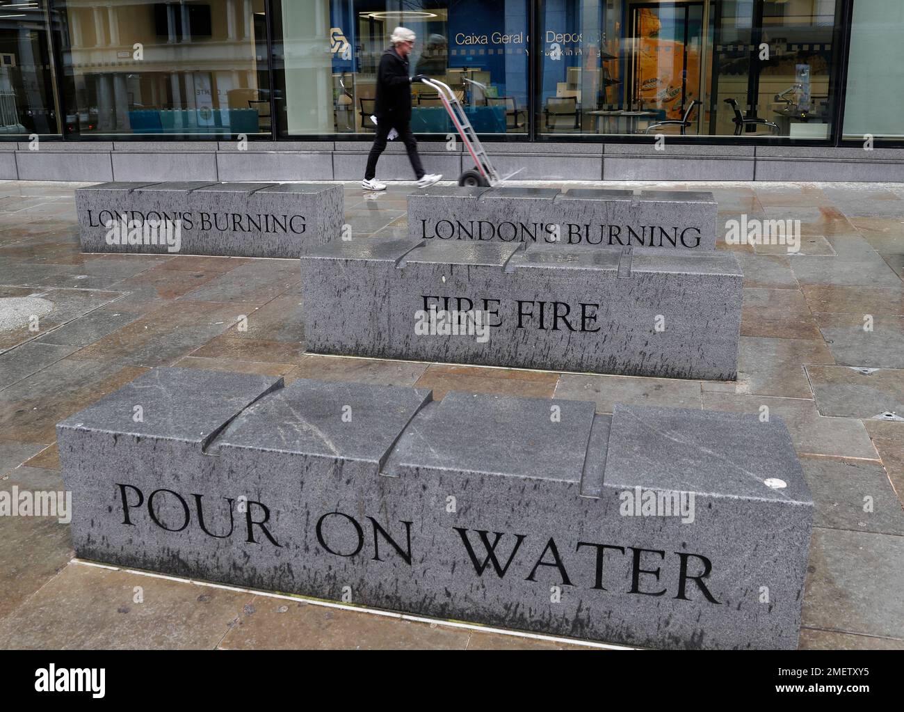 Words from a nursery rhyme written on the sides of stone benches at the