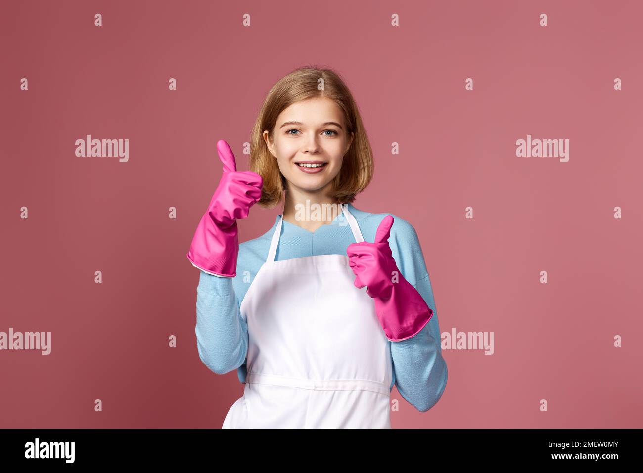 woman in rubber gloves and cleaner apron showing ok sign Stock Photo ...