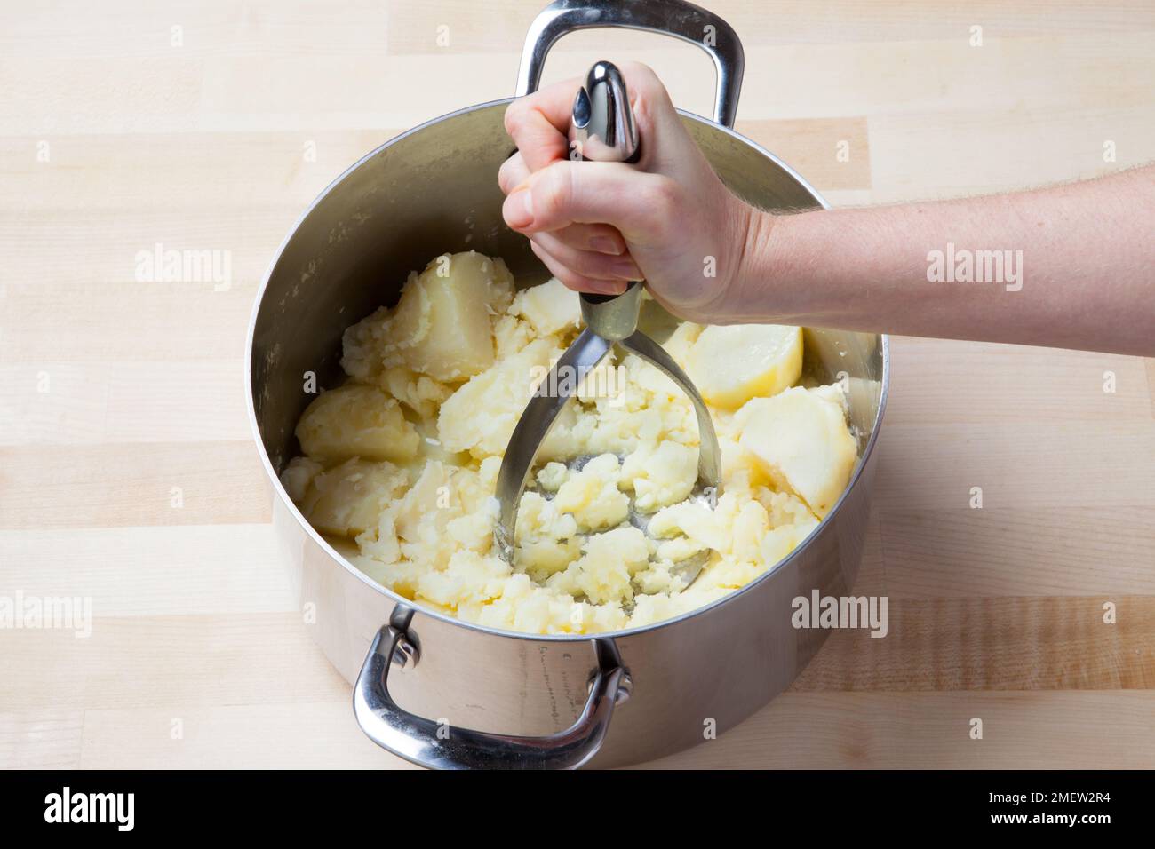 Mashing potatoes Stock Photo
