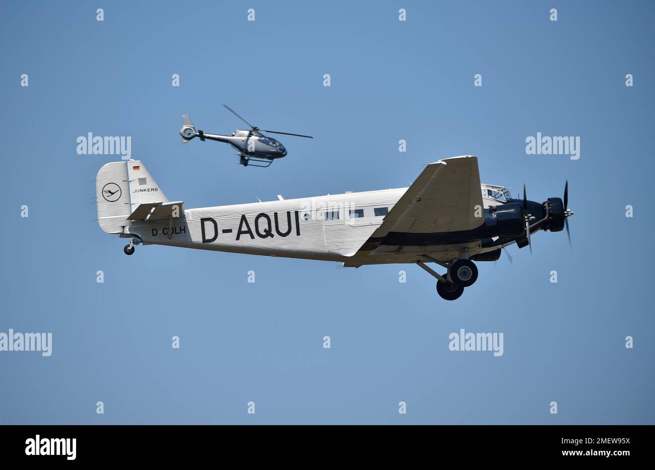Propeller plane Ju 52 and helicopter flying over Hesse, Germany
