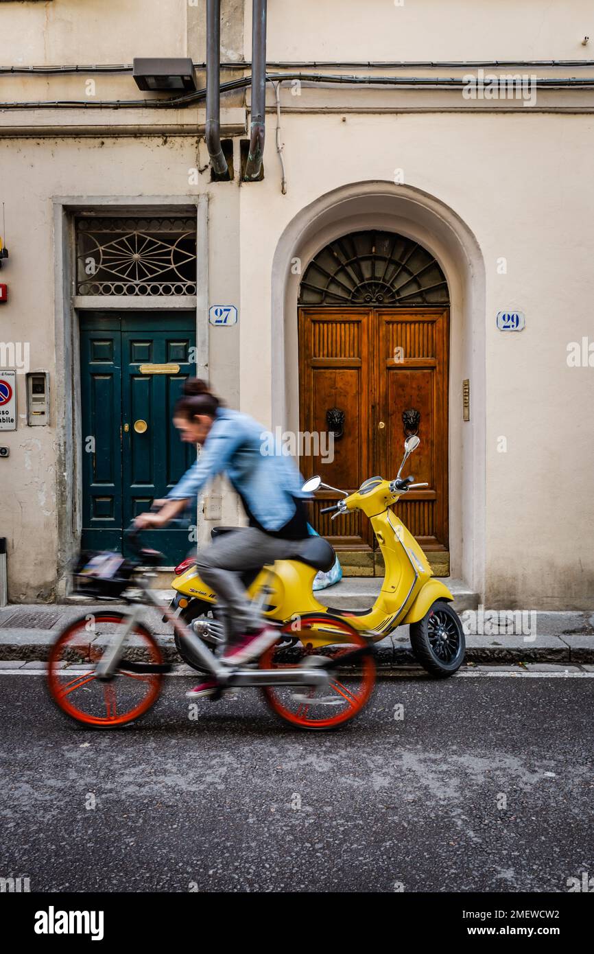 Woman on bicycle in the streets of Florence, Tuscany, Italy. Stock Photo