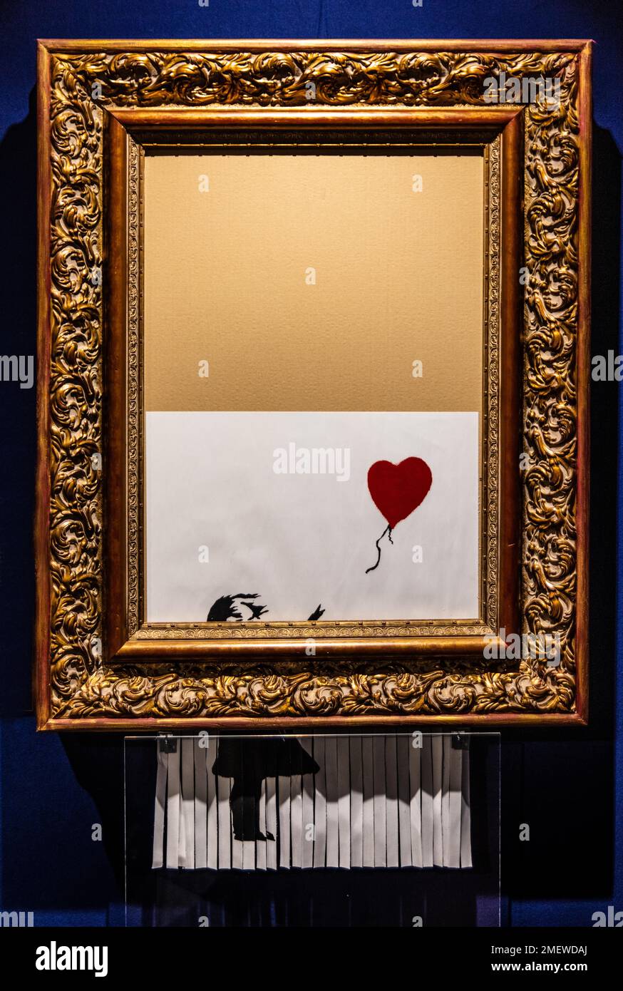Girl with Balloon, was partially destroyed at an auction by a shredder built into the frame, 2002, Banksy, exhibition about the street artist Stock Photo