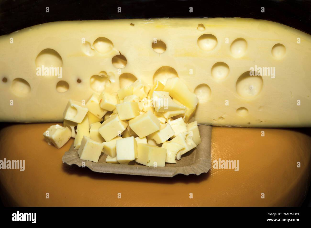 Cheese cubes of a kind of Emmental, food photography with black