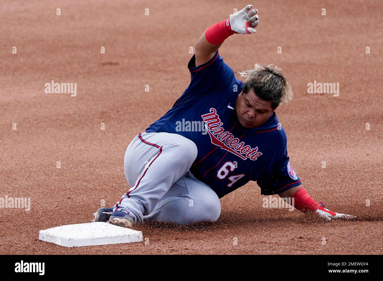 Minnesota Twins catcher Willians Astudillo (64) slides into second base  with a double against the Boston Red Sox during a spring training baseball  game Sunday, March 28, 2021, in Fort Myers, Fla. (