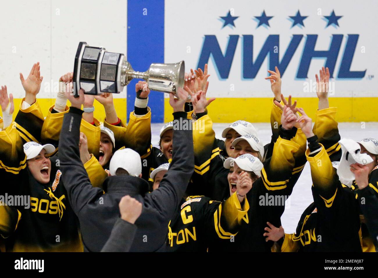 Boston Pride players and coaches celebrate with the NWHL Isobel Cup