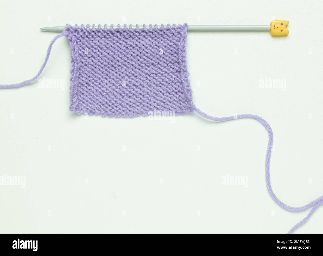 Stocking stitch in lilac yarn, showing knit and purl sides Stock Photo