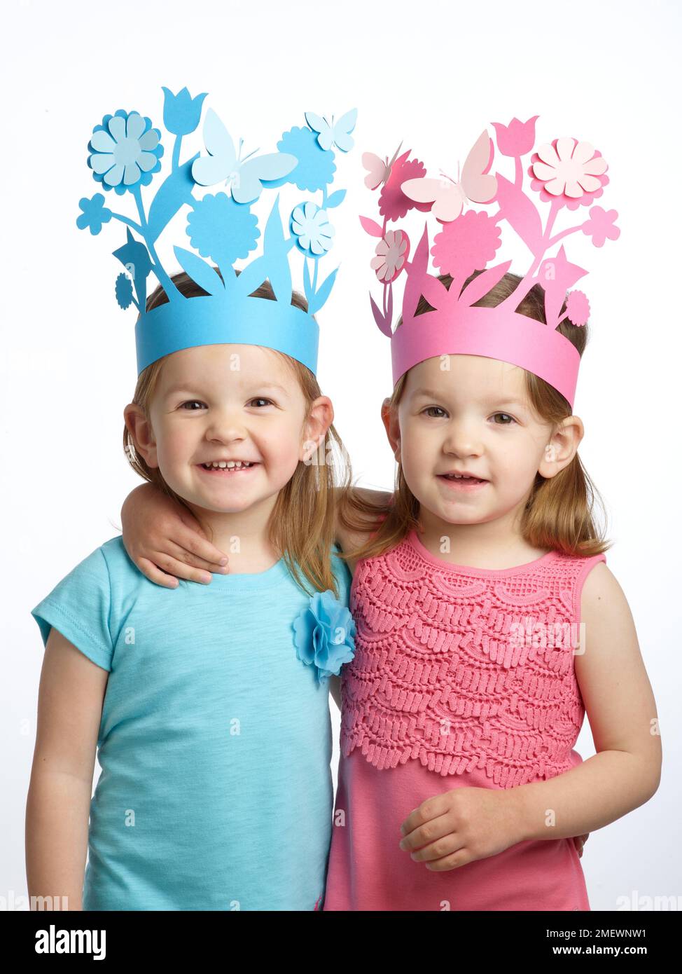 Papercraft Paper crowns twin girls in matching flower crown Stock Photo